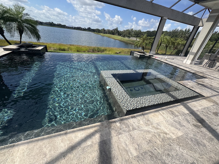 Sparkling residential Florida pool with spa overlooking the water
